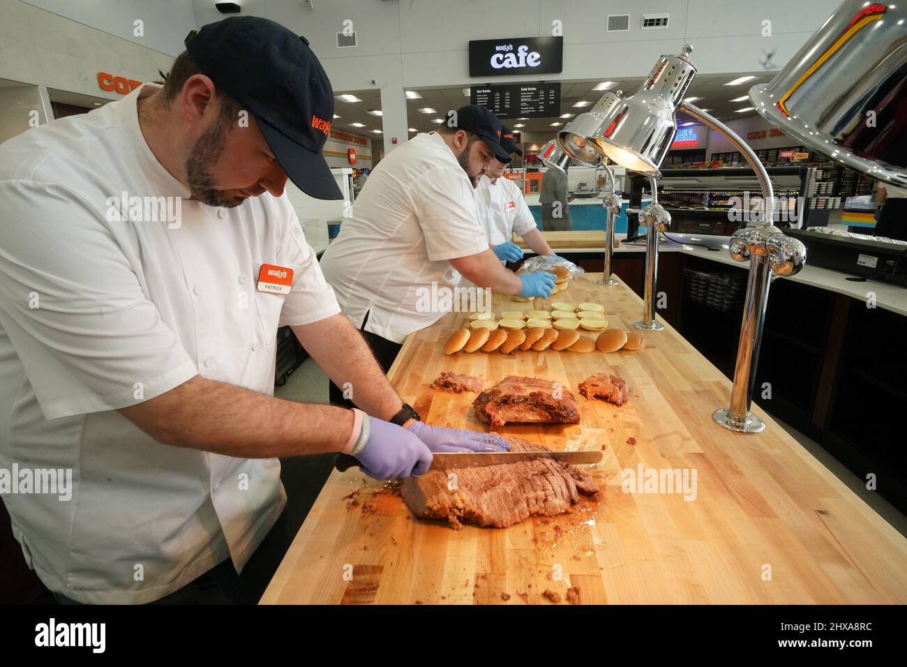 Fenton, USA. 10th Mar, 2022. Food workers prepare tenderloin beef sandwiches practicing for the grand opening at Wally's in Fenton, Missouri on Thursday, March 10, 2022. Wally's is a 36 thousand square facility, with 72 separate gas pumps spanning two football fields long. Inside, the traveler is greeted by many food options plus a travel store with clothing, home items and supplies for hunting and camping. The largest store of its kind in the area will open on Friday, March, 11, 2022. Photo by Bill Greenblatt/UPI Credit: UPI/Alamy Live News Stock Photo