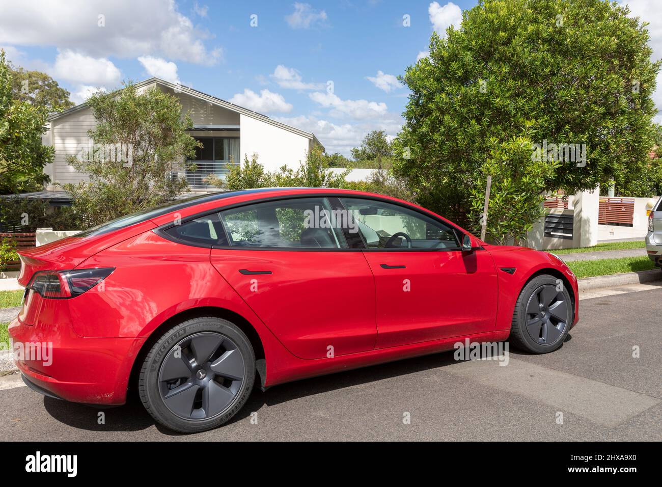 2022 red Tesla Model 3 car parked in a Sydney street, NSW,Australia Stock Photo