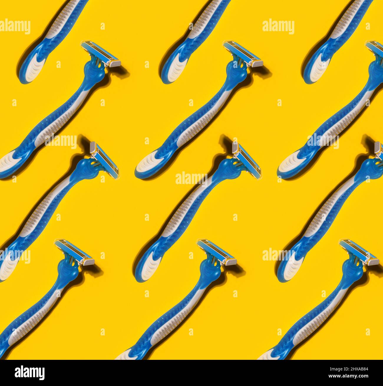 pattern with disposable shaving razors on yellow background Stock Photo