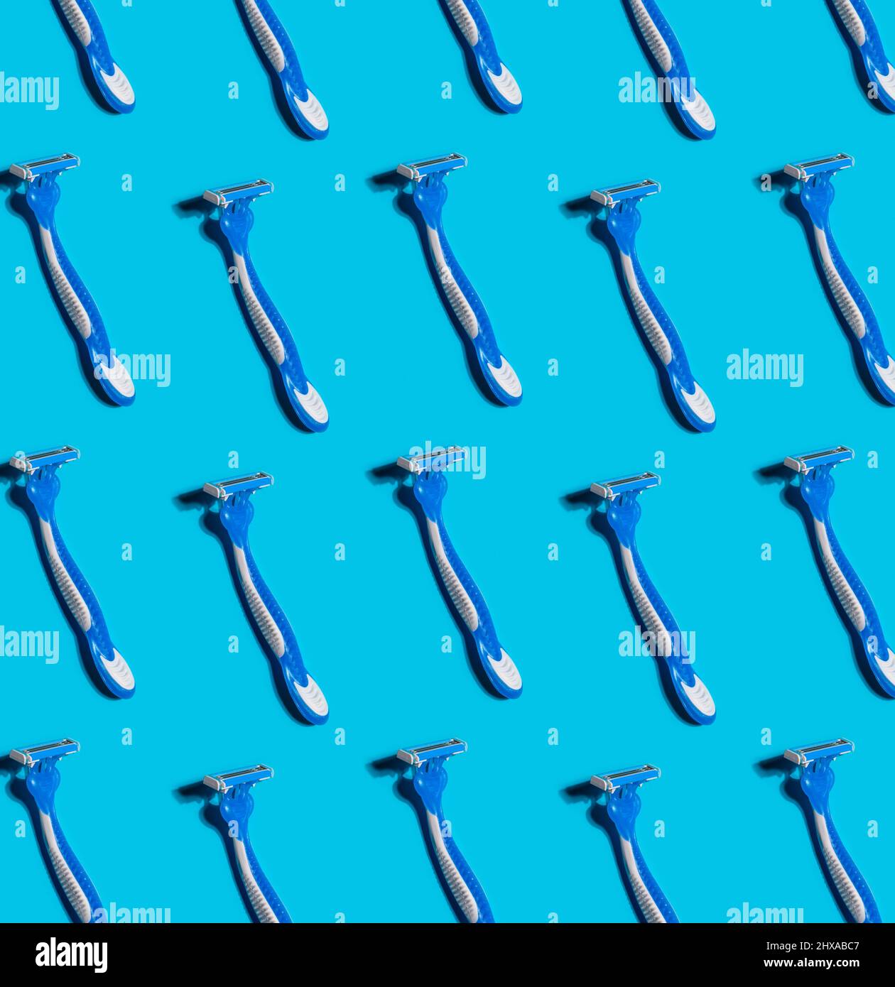 pattern with disposable shaving razors on blue background Stock Photo