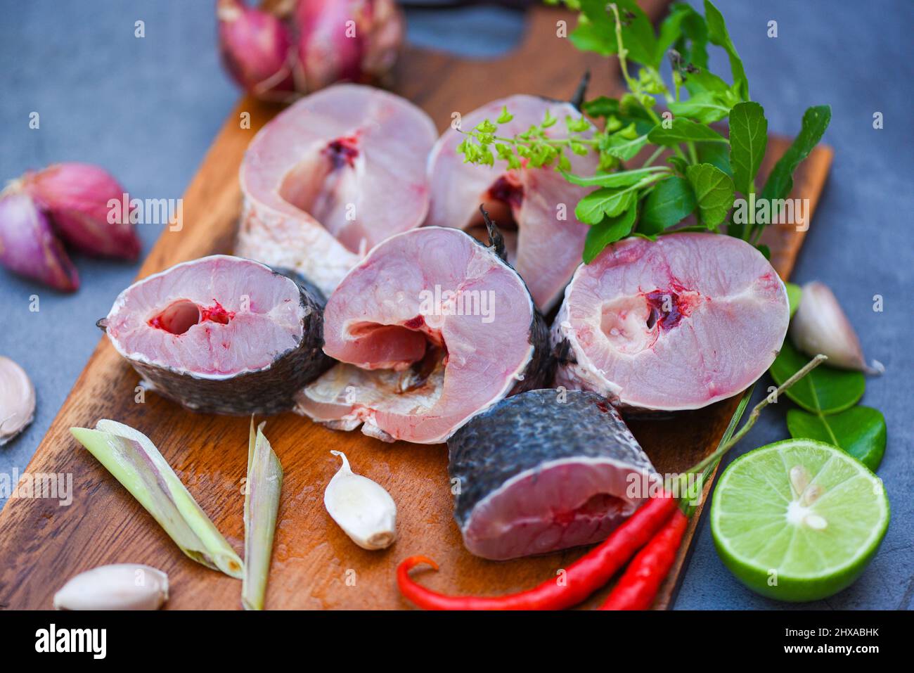 Fresh raw Snake head fish menu freshwater fish, Snakehead fish for cooking food, striped snakehead fish chopped with ingredients herb and spices on wo Stock Photo