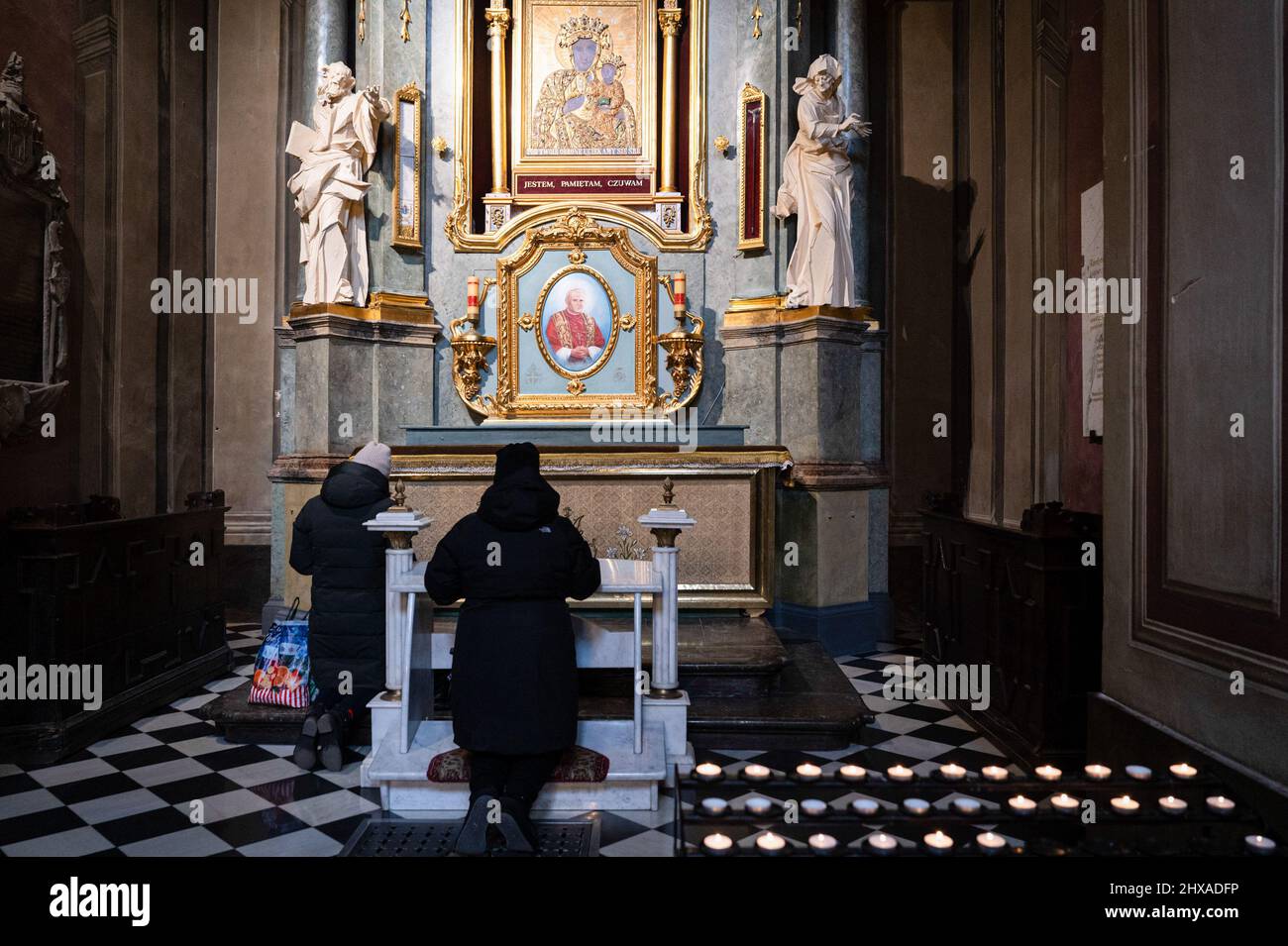 Lviv, Ukraine. 10th Mar, 2022. People are seen praying inside the Cathedral. The Polish Cardinal Konrad Krajewski, the Papal Almoner in Ukraine, attended the interfaith prayer service at the Cathedral of the Assumption of the Blessed Virgin Mary (Lviv Metropolitan Basilica) in Lviv at the presence of representatives of the Pan-Ukrainian Council of Churches and different religious communities. Credit: SOPA Images Limited/Alamy Live News Stock Photo