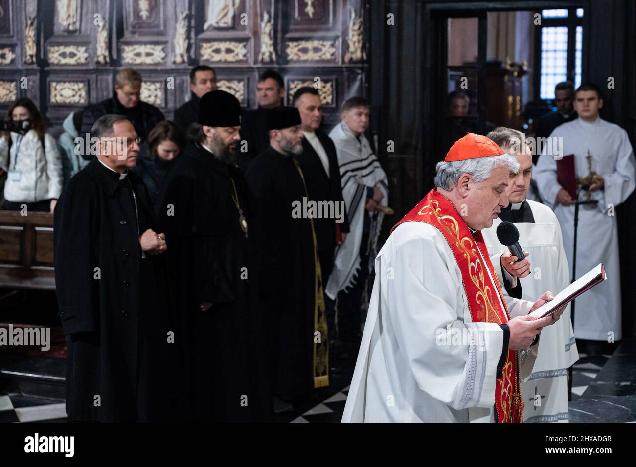 Lviv, Ukraine. 10th Mar, 2022. Cardinal Konrad Krajewsk (R2) leads the service. The Polish Cardinal Konrad Krajewski, the Papal Almoner in Ukraine, attended the interfaith prayer service at the Cathedral of the Assumption of the Blessed Virgin Mary (Lviv Metropolitan Basilica) in Lviv at the presence of representatives of the Pan-Ukrainian Council of Churches and different religious communities. Credit: SOPA Images Limited/Alamy Live News Stock Photo