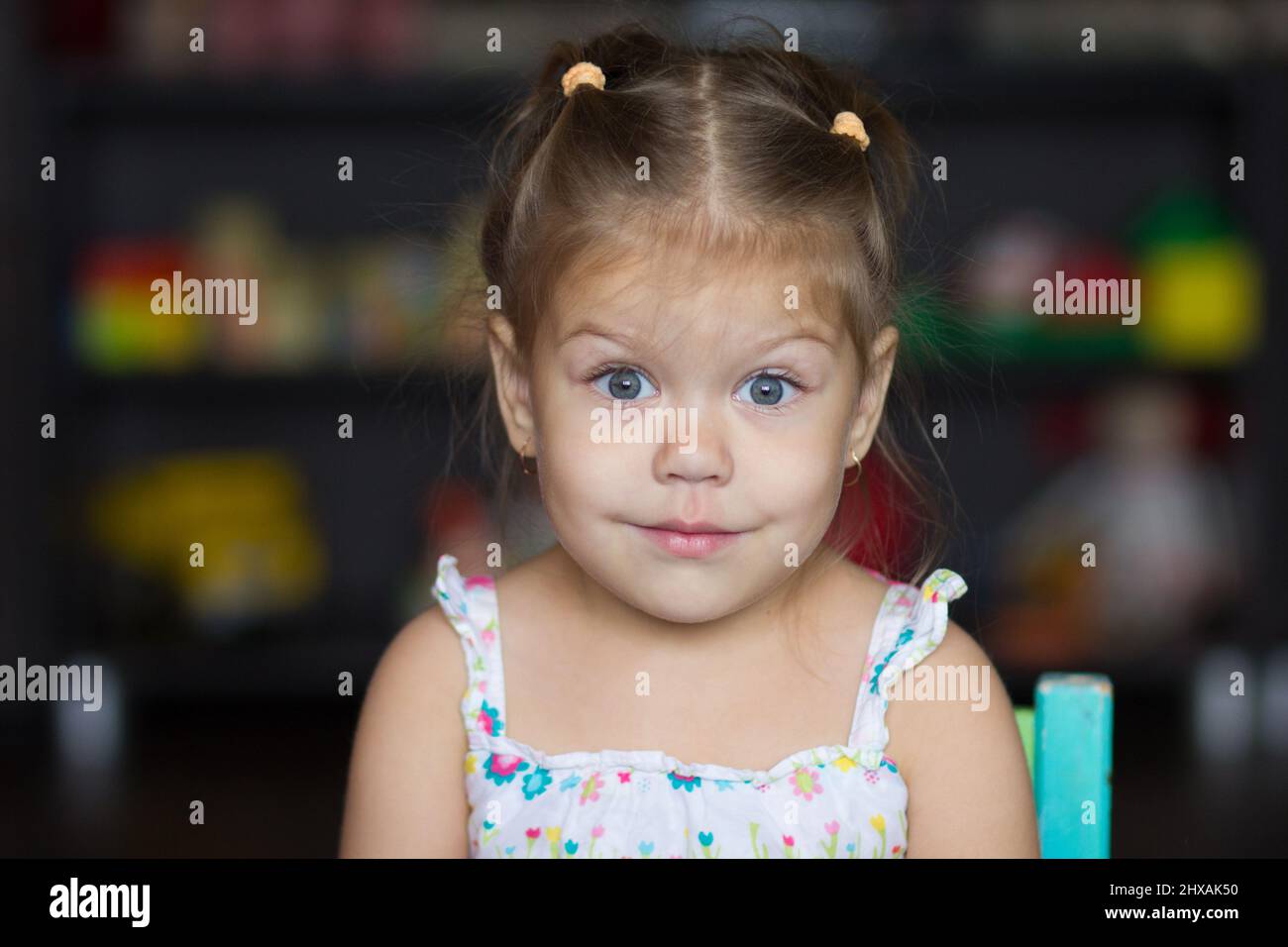Portrait of the cute little girl looking at camera Stock Photo - Alamy