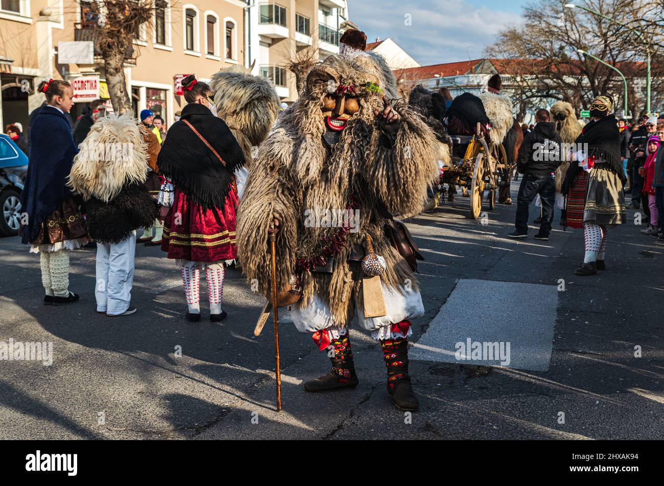 02.28.2022. Mohacs hungary. carnival festival when the winter is ending. Preformers wearing Traditional clotes and masks. They are dancing, walking, Stock Photo