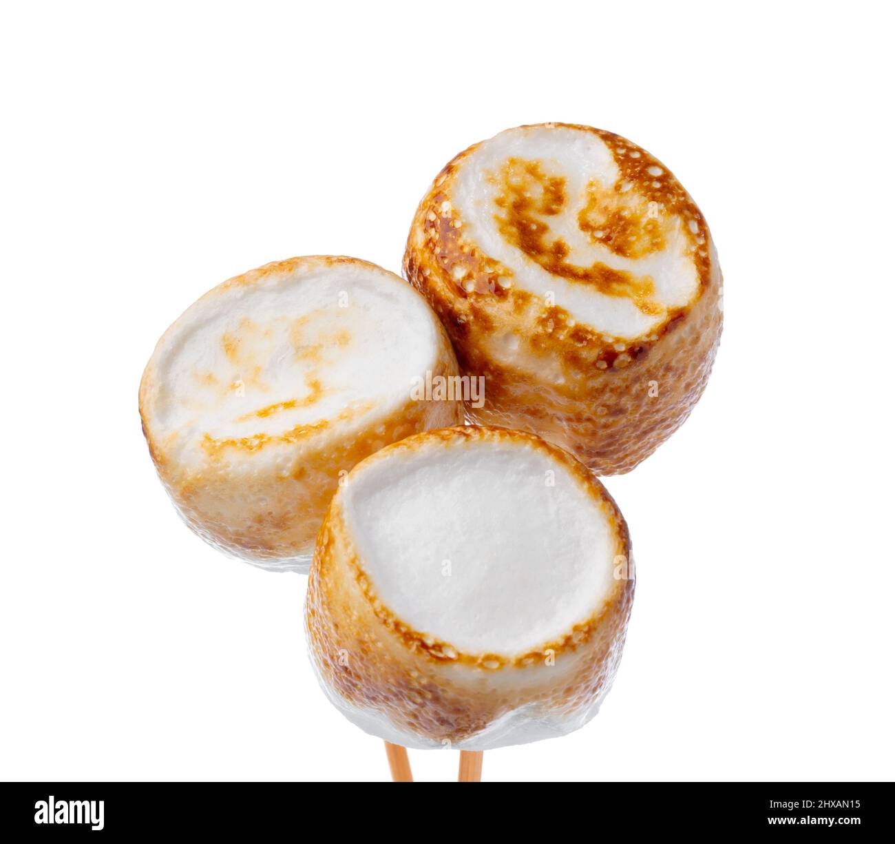 Grilled marshmallows on sticks isolated on white Stock Photo