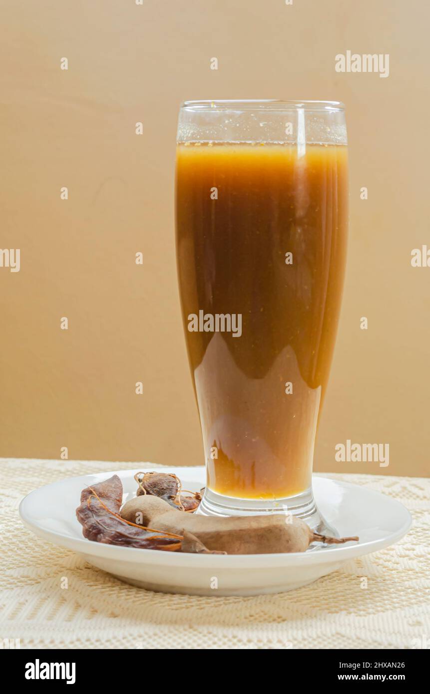 Side View Of Tamarind Juice In Drinking Glass Stock Photo