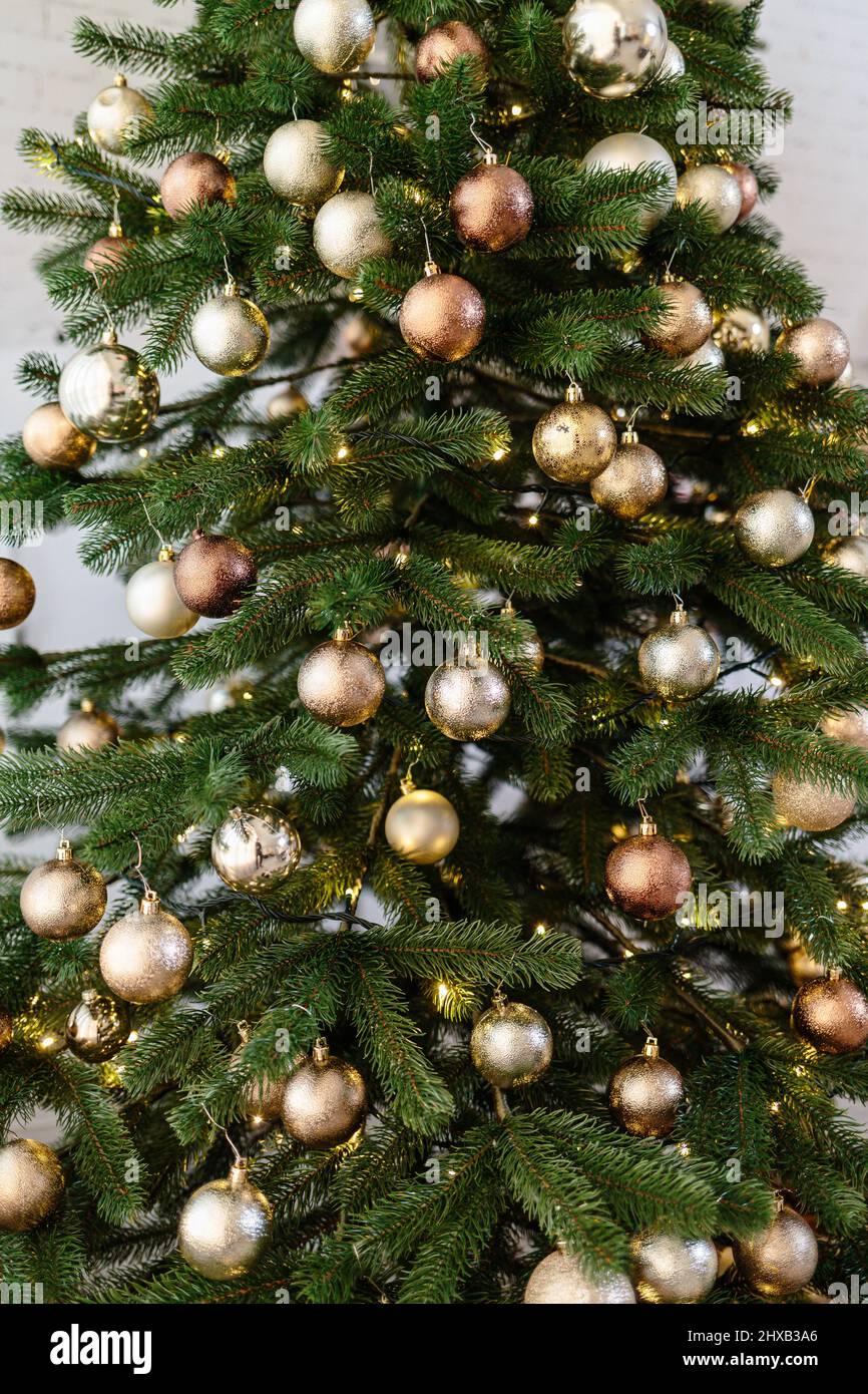 The tree is decorated with colorful toys and a garland. Close-up photo ...