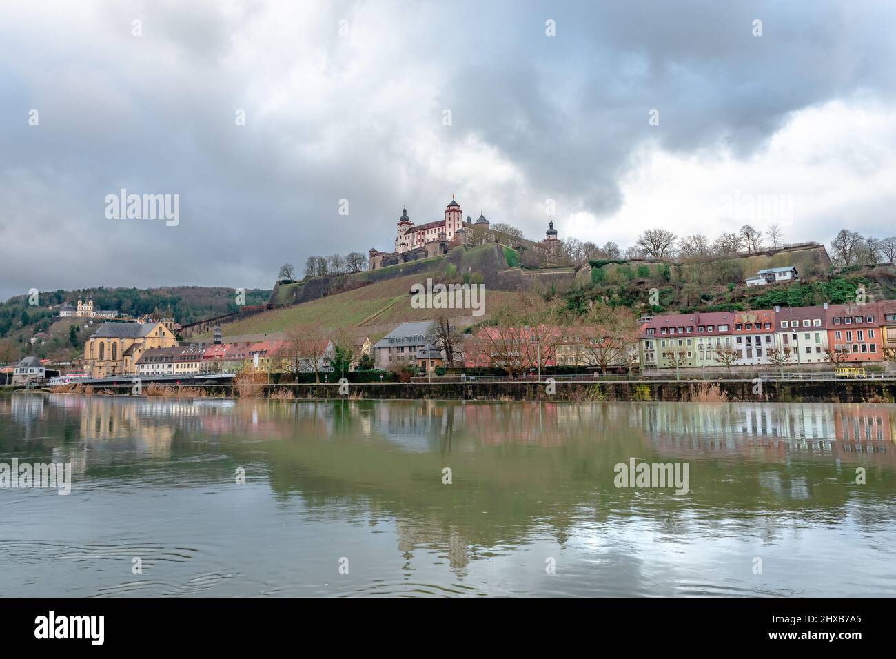 View of the western bank of the river Main that crosses Wurzburg, in Bavaria, Germany, with the Marienberg Fortress dominating the background. Stock Photo