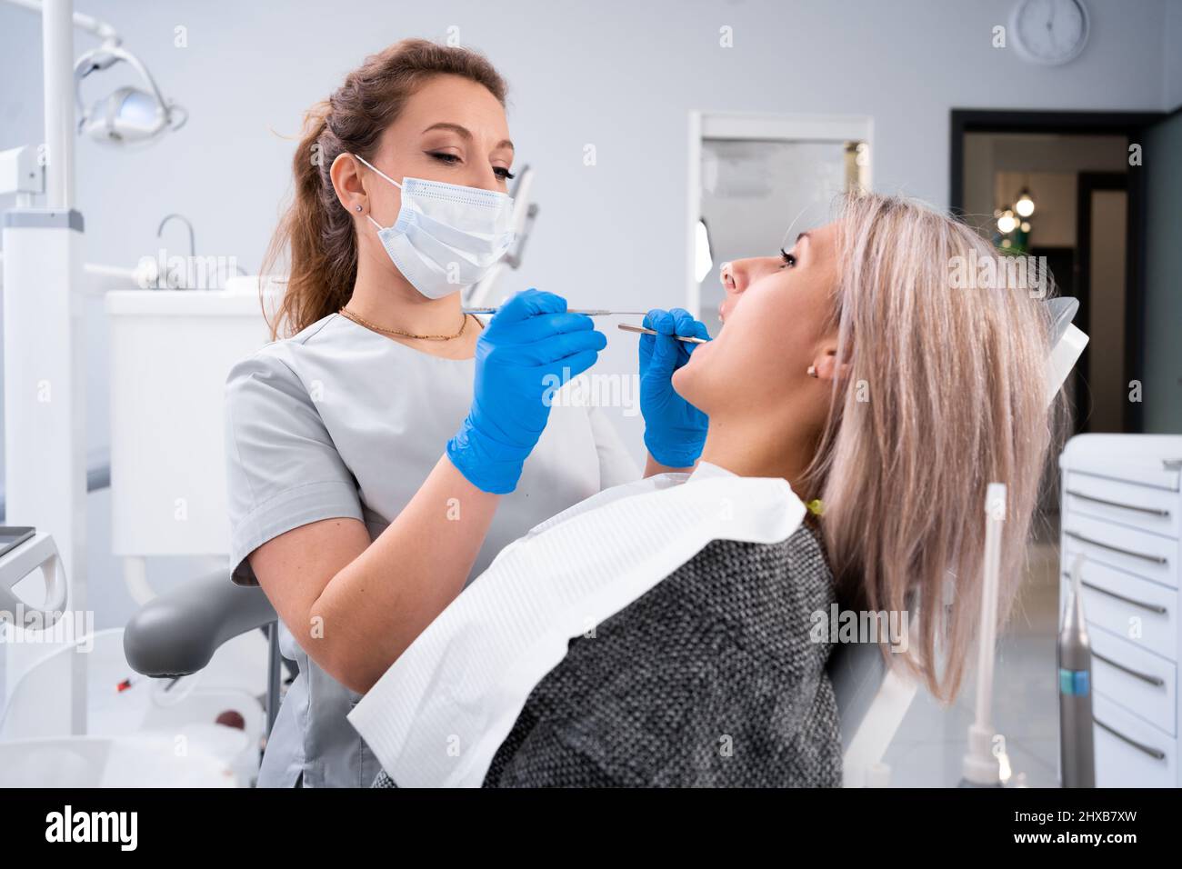 A professional dentist examines and treats damaged teeth using special