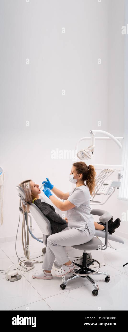 Injection of anesthetic anesthesia. Dentist treats patient's teeth in