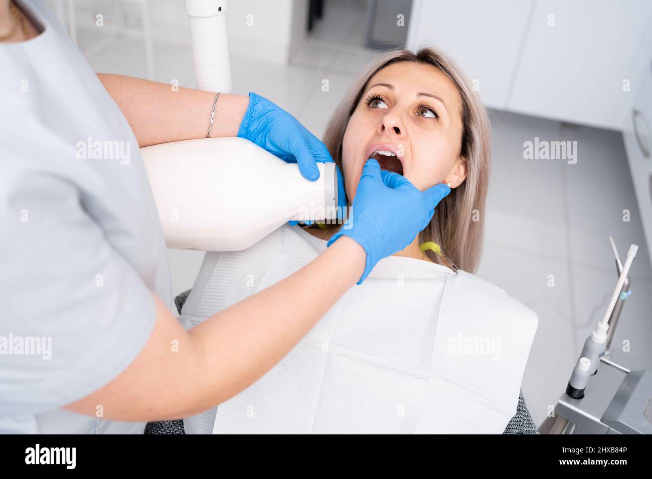 appointment with a dentist. Woman doctor dentist makes xray of teeth