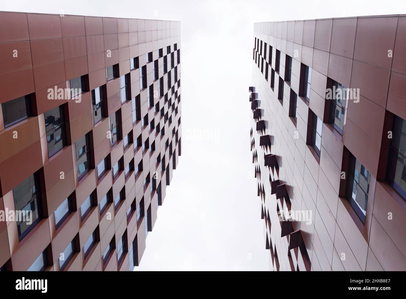 Looking up into a pale grey sky between to similar high-rise (Urbanest) buildings in Ultimo, Sydney, Australia Stock Photo