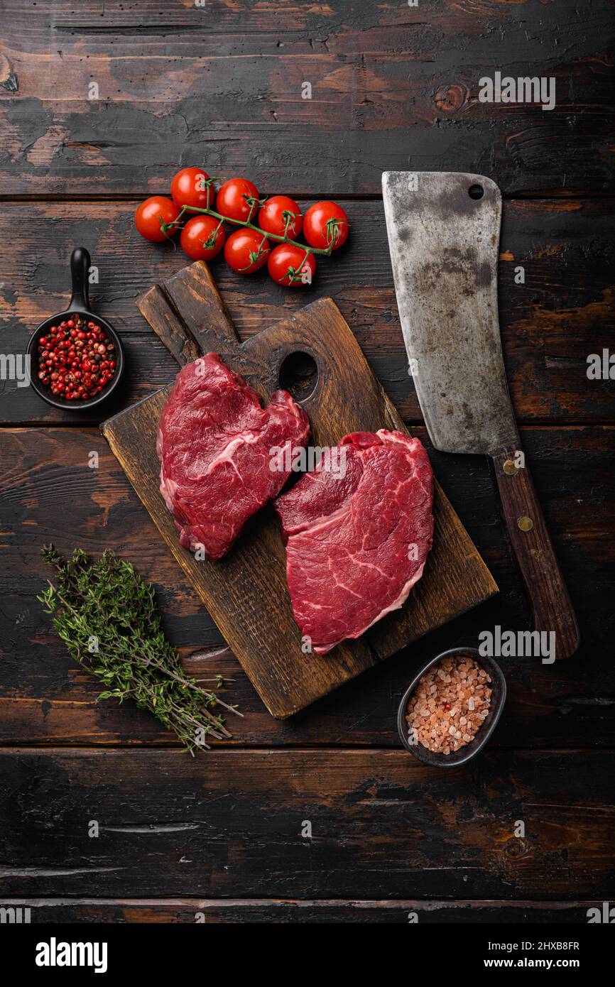 Beef raw rump steak with salt pepper rosemary set, on old dark wooden ...