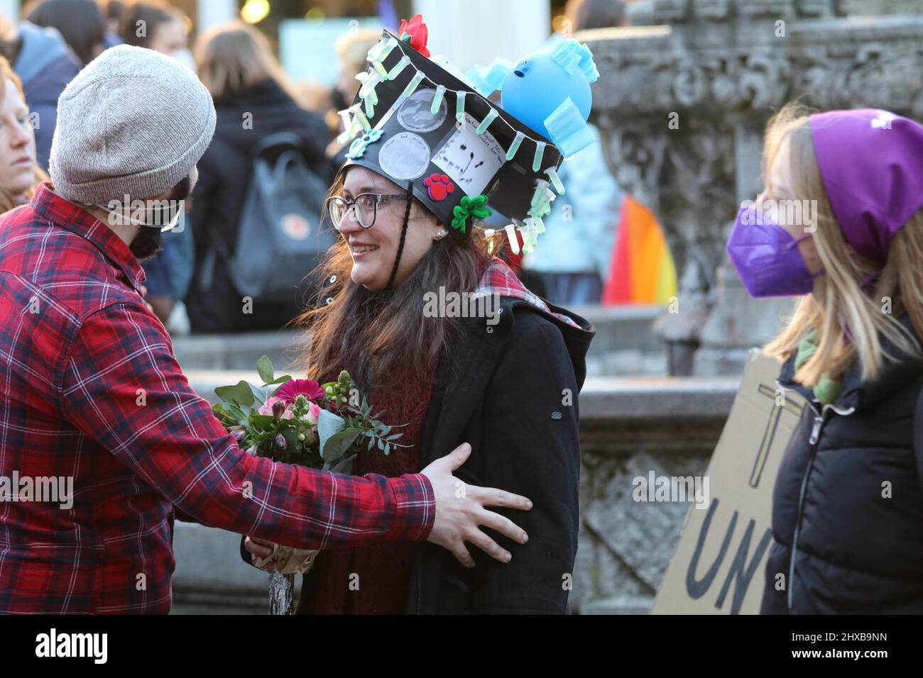 PhD graduate woman celebrate on Gänseliesel statue on the occasion of International Women's Day in Göttingen, Germany. By tradition PhD graduates climb Gaenseliesel fountain in centeral of Göttingen city, kiss the goose girl and give her flowers. Credit: Pacific Press Media Production Corp./Alamy Live News Stock Photo