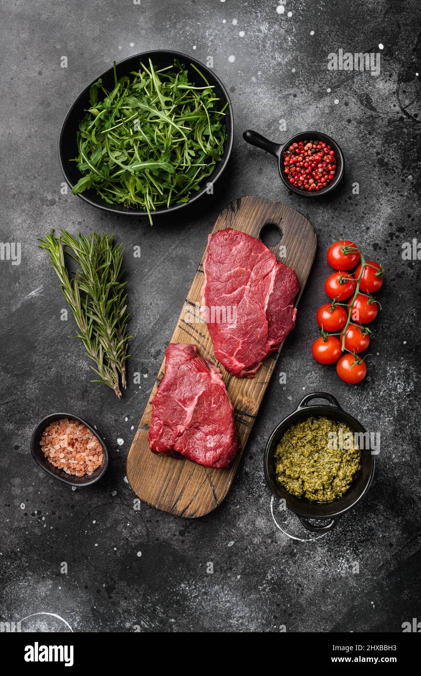Fresh raw Beef meat Rump Steak set, on black dark stone table ...