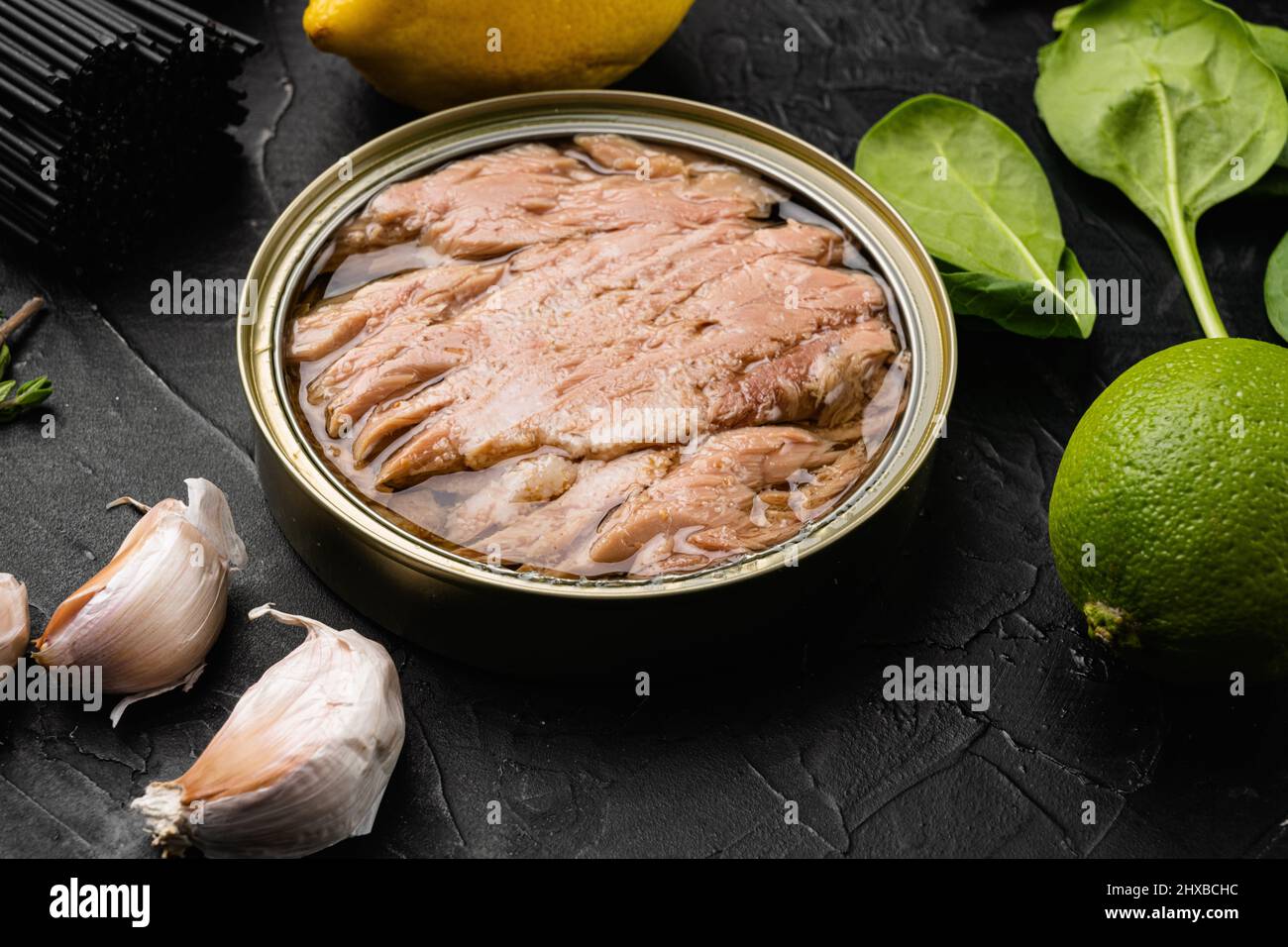 Canned tuna fish set, on black dark stone table background Stock Photo