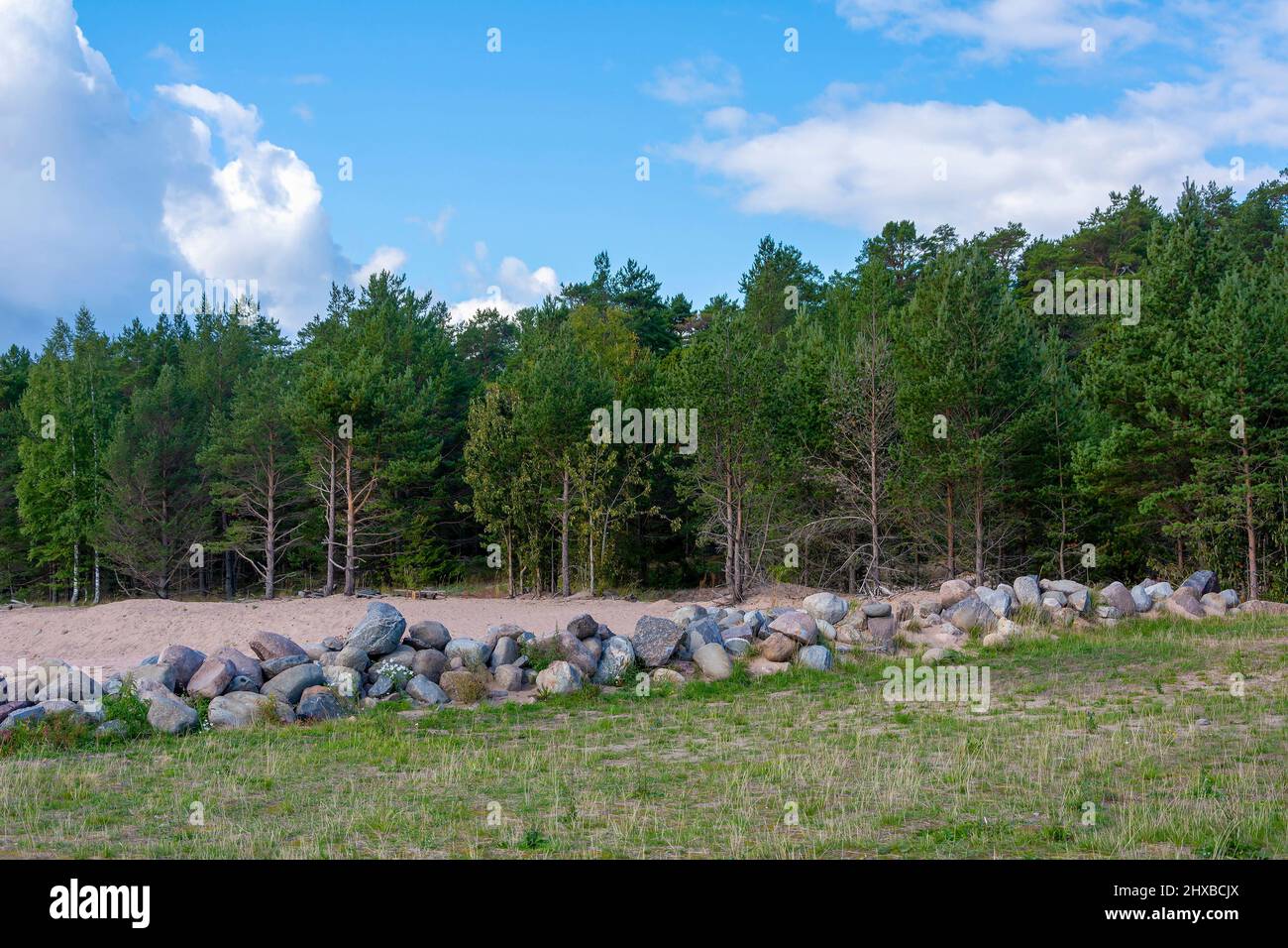 The stone embankment is part of the old wharf on the pier of the Konevetsky monastery, in the Vladimir Bay of Lake Ladoga Stock Photo