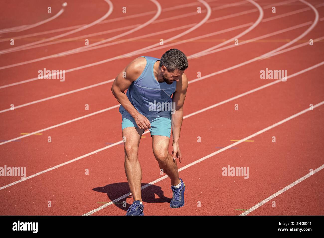 sportsman feel hurt. sharp pain. muscular guy has sport trauma. man