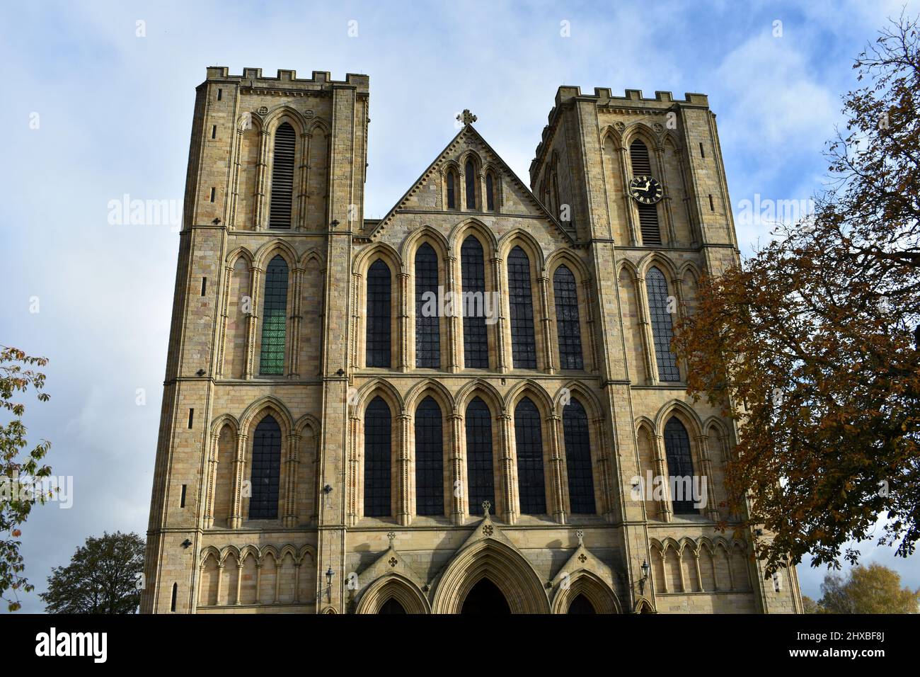 close up landscape image of majestic Ripon cathedral, the stone historical structure standing tall  on a beautiful sunny day in Autumn Stock Photo