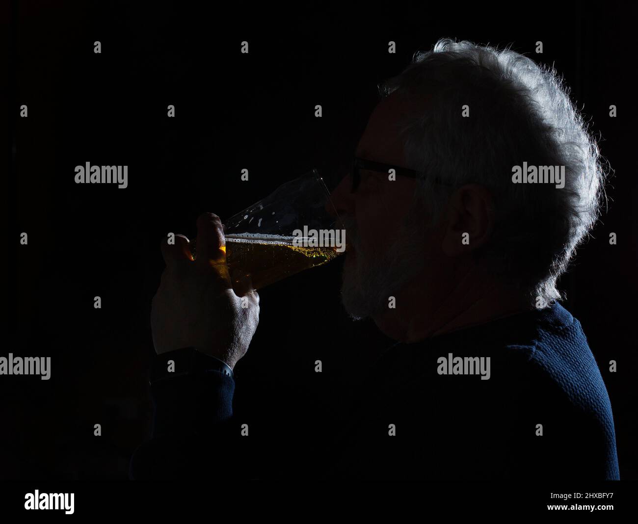A man drinking a pint of larger Stock Photo