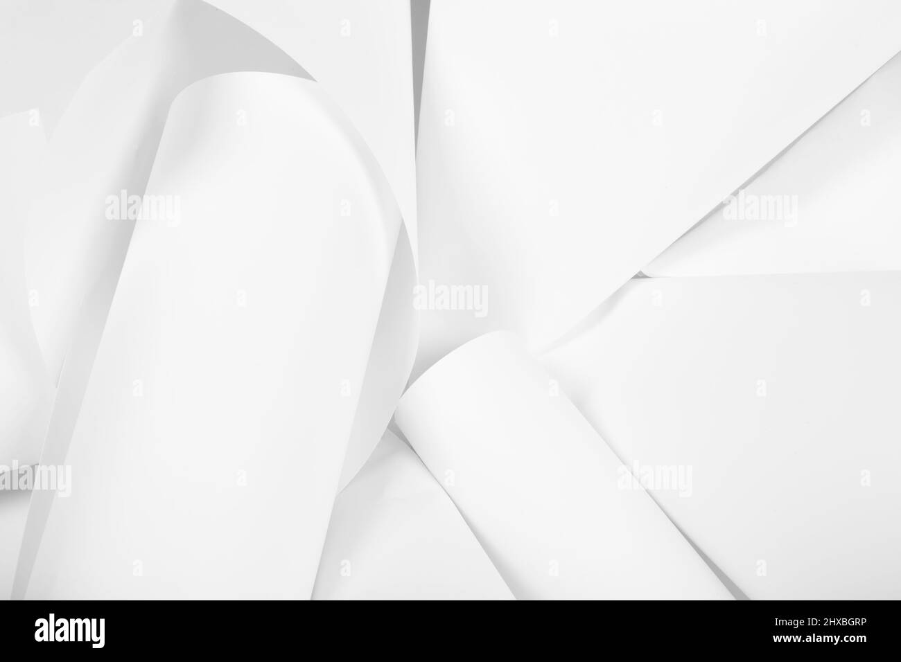 White sheets of office paper are twisted and scattered. Paper white abstract background Stock