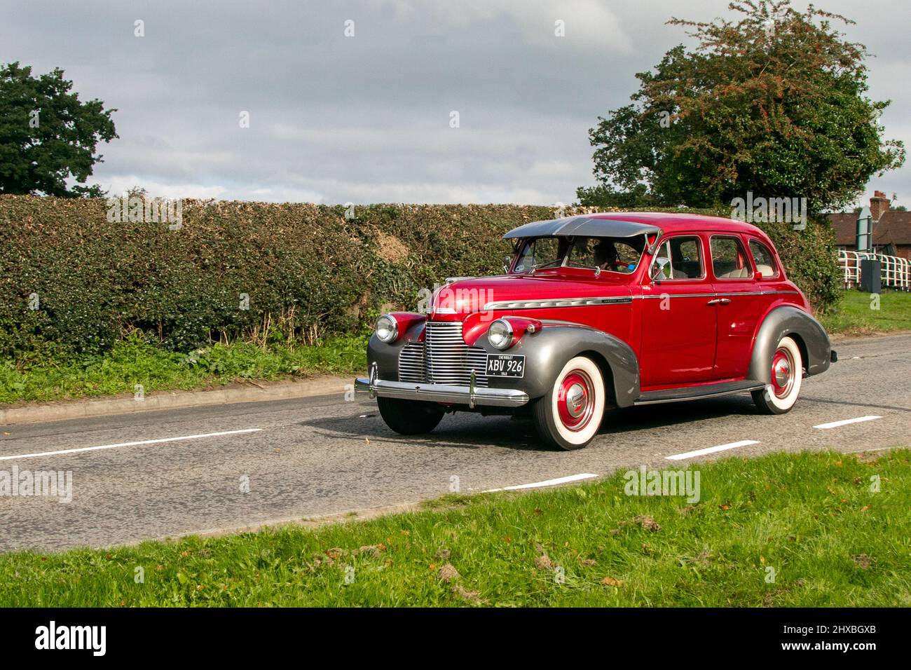 1940 40s pre-war red Chevrolet 3800cc petrol 4dr sedan; en-route to Capesthorne Hall classic August car show, Cheshire, UK Stock Photo