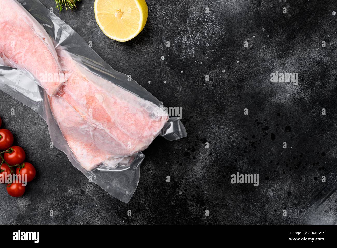Orange roughy frozen pack fish meat set, with herbs, on black dark ...