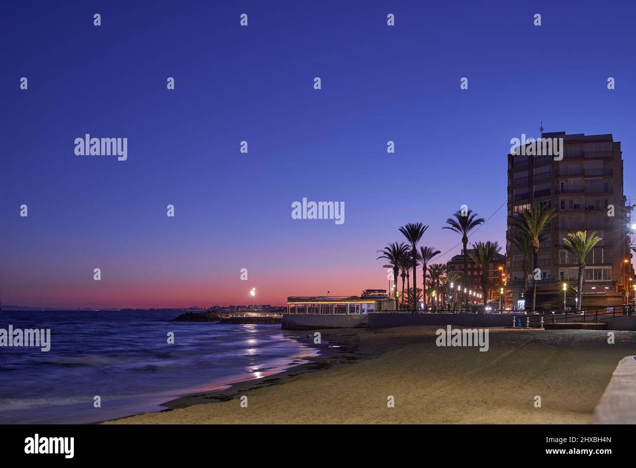 Seafront at popular Playa del Cura beach in Torrevieja. Alicante. Spain. Ttourist resort city at dawn, sunset Stock Photo