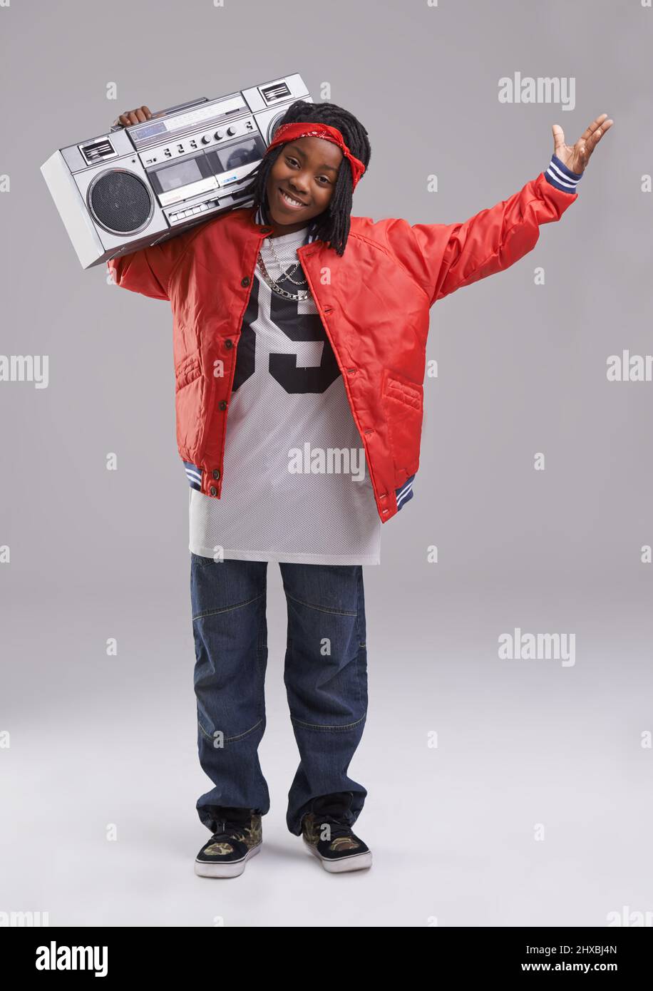 What do you think. Studio shot of a young boy dressed in hip hop attire. Stock Photo