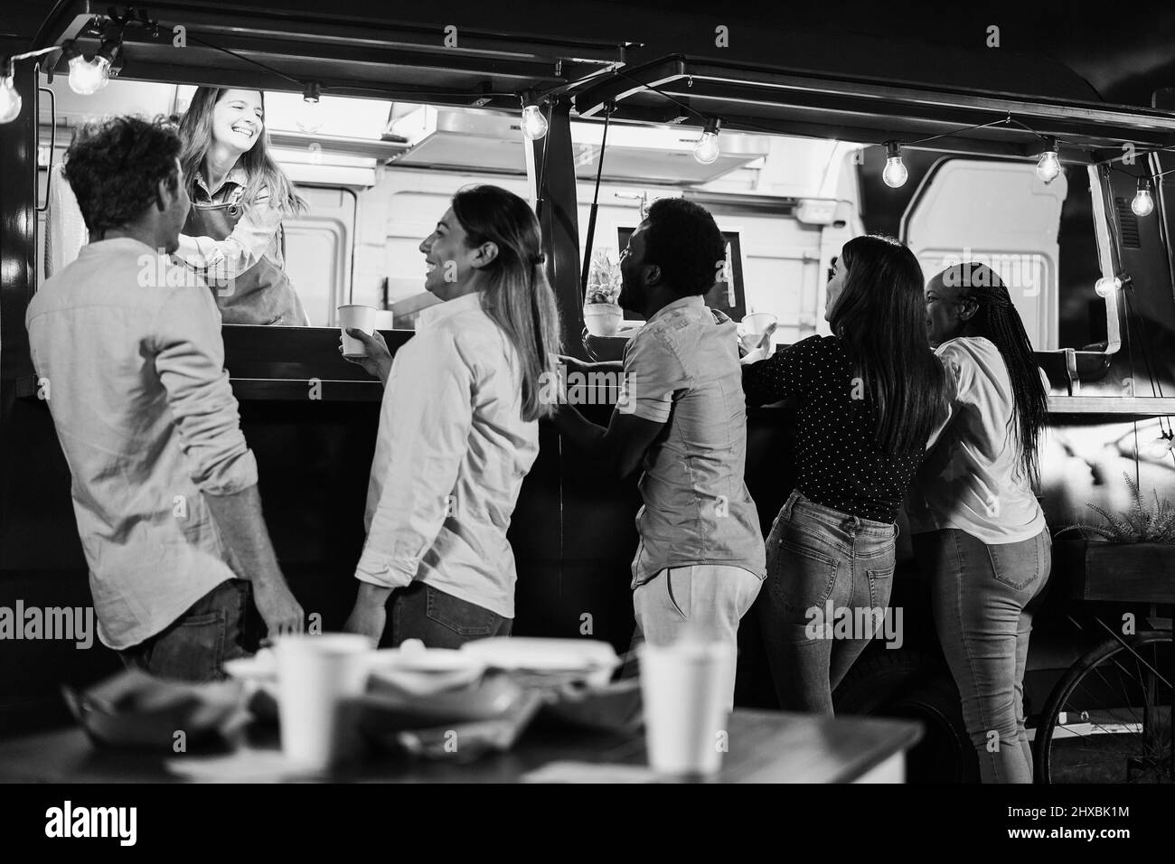 Multiracial people ordering food at counter in take away food truck outdoor - Focus on african man face Stock Photo