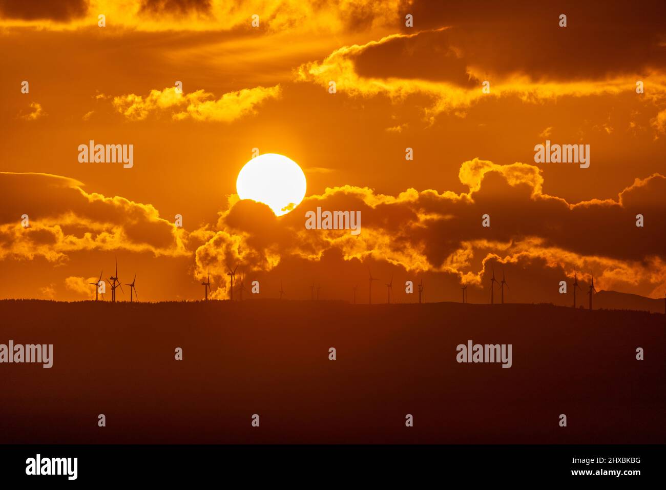 Sunset over wind turbines in the Vale of Clwyd, North Wales Stock Photo