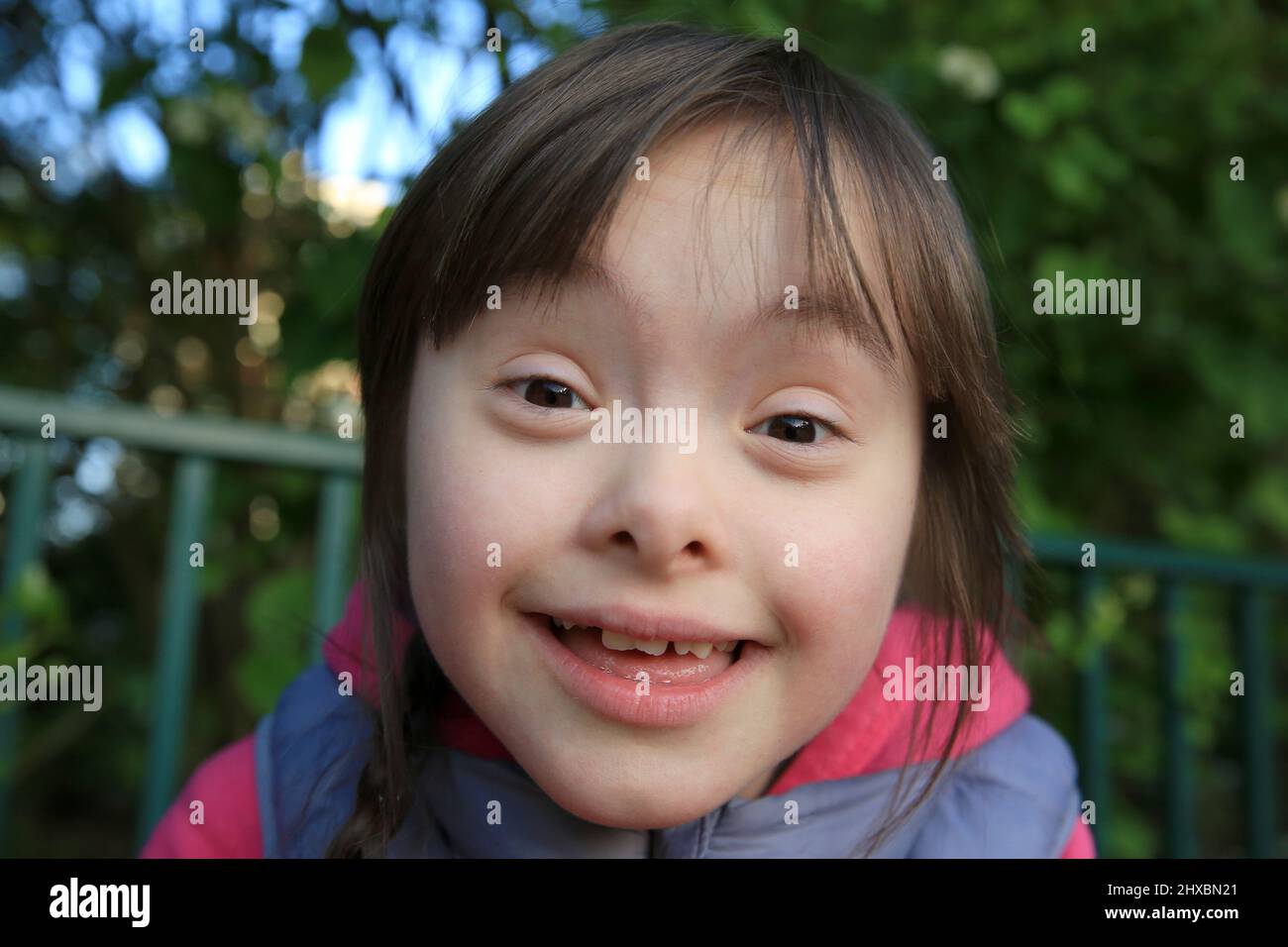 Portrait of little girl smiling outside Stock Photo - Alamy