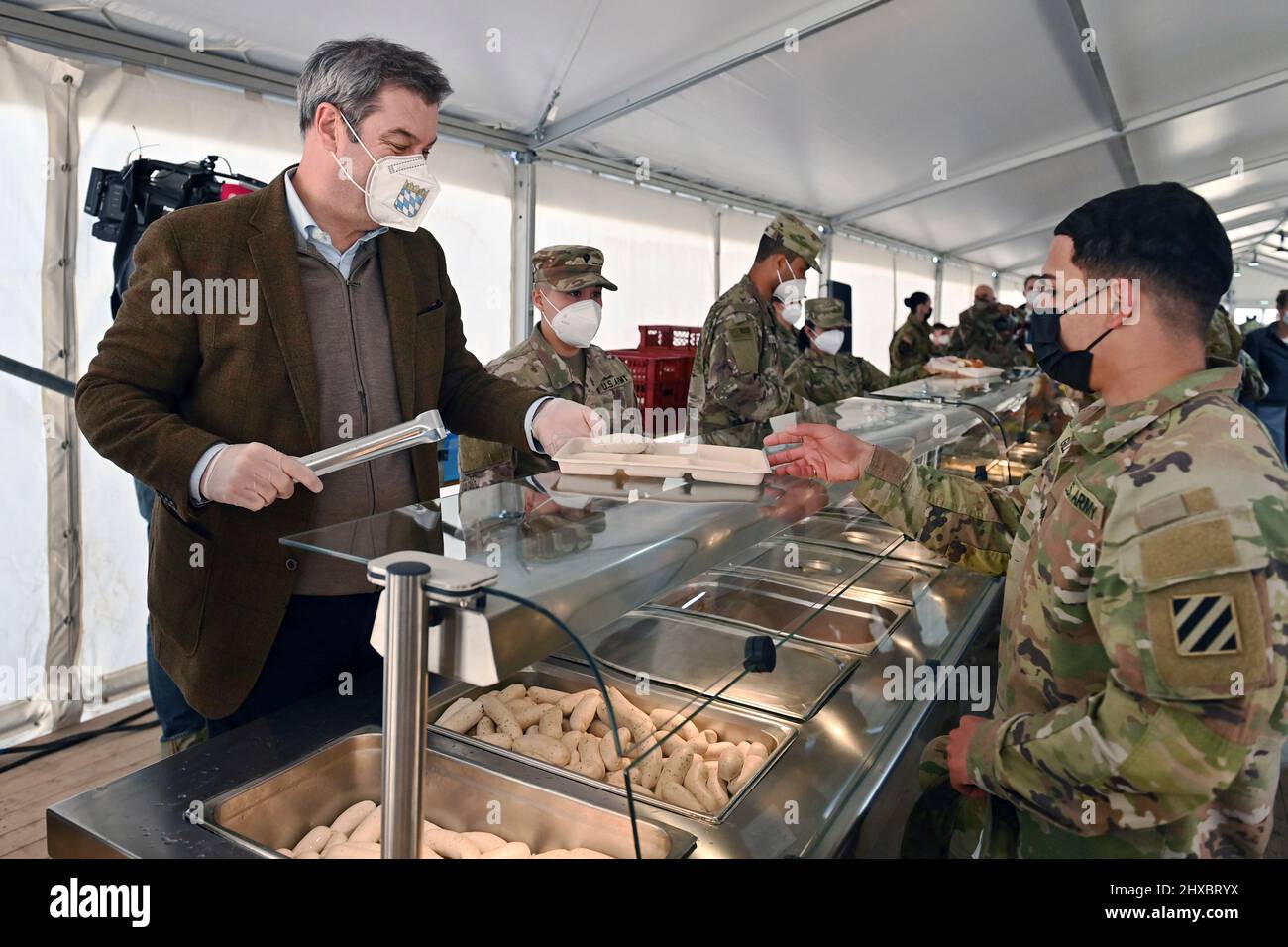 Markus SOEDER (Prime Minister of Bavaria and CSU Chairman) at the food distribution at the Weisswurst counter, Weisswurst Essen.Bavarian Weisswurst breakfast. Prime Minister Dr. Markus Soeder visits the US military training area Grafenwoehr, headquarters of the 7th Army Training Command on March 11th, 2022. Stock Photo