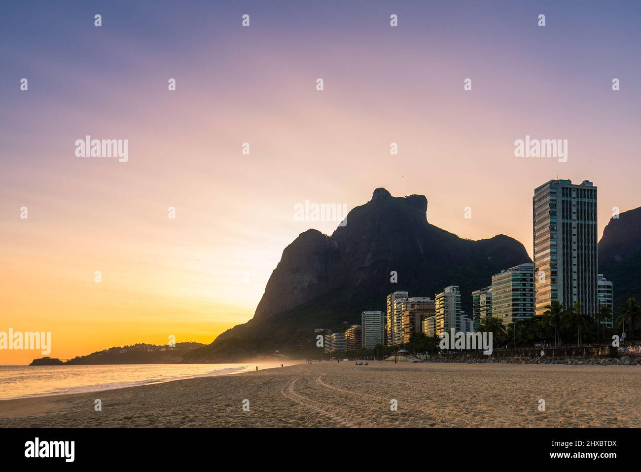 Warm Sunset at Empty Sao Conrado Beach in Rio de Janeiro With Luxury Apartment Buildings and Pedra da Gavea View Stock Photo