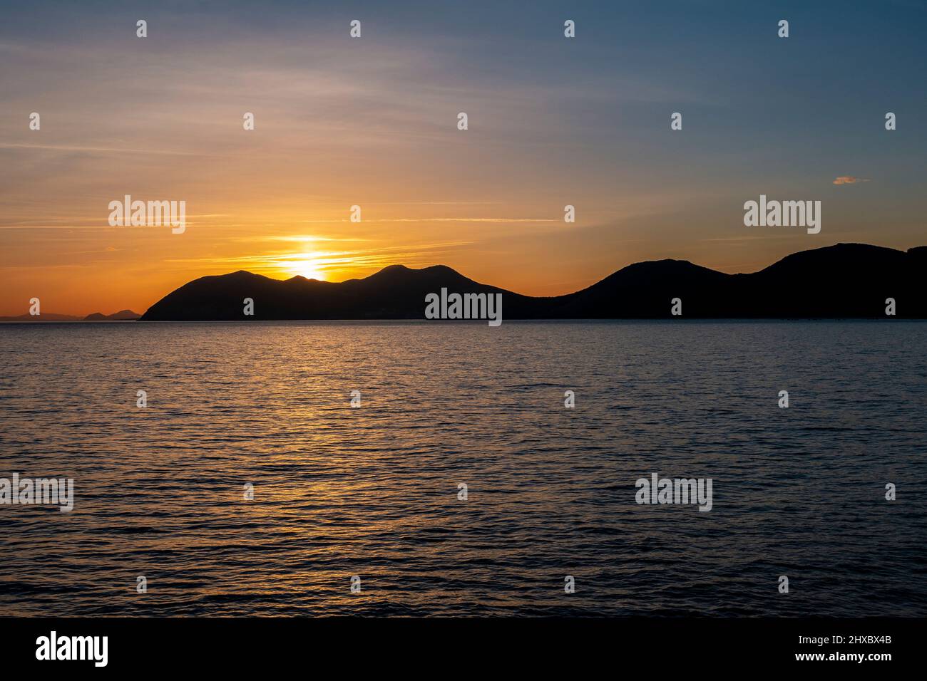 Silhouette of mountains at sunset viewed from Noja looking towards the Pico Del Monte Buciero in Santoña, Cantabria, Spain Stock Photo