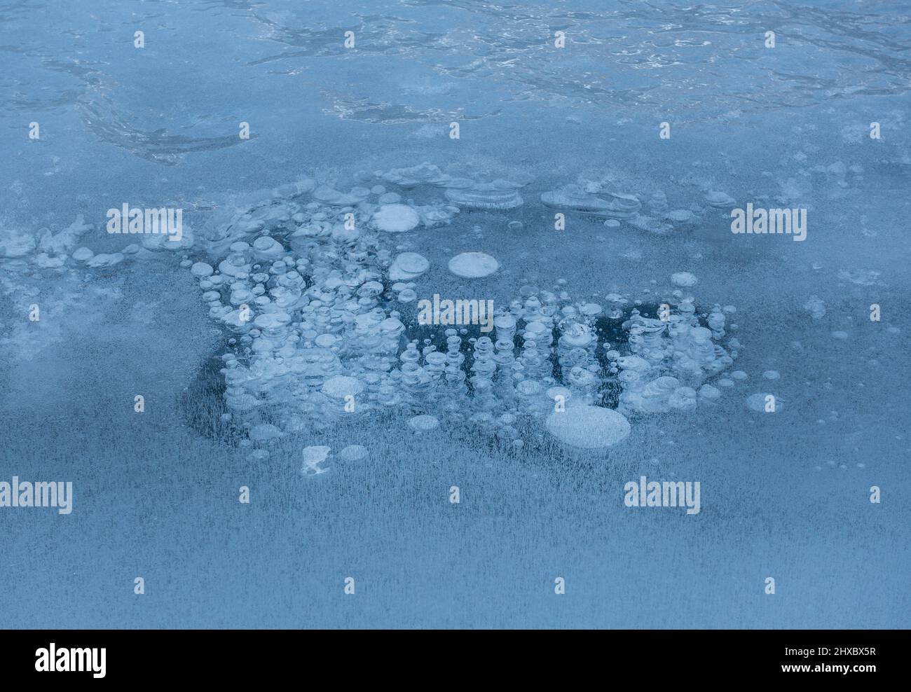 Bubbles of air trapped in frozen ice Stock Photo