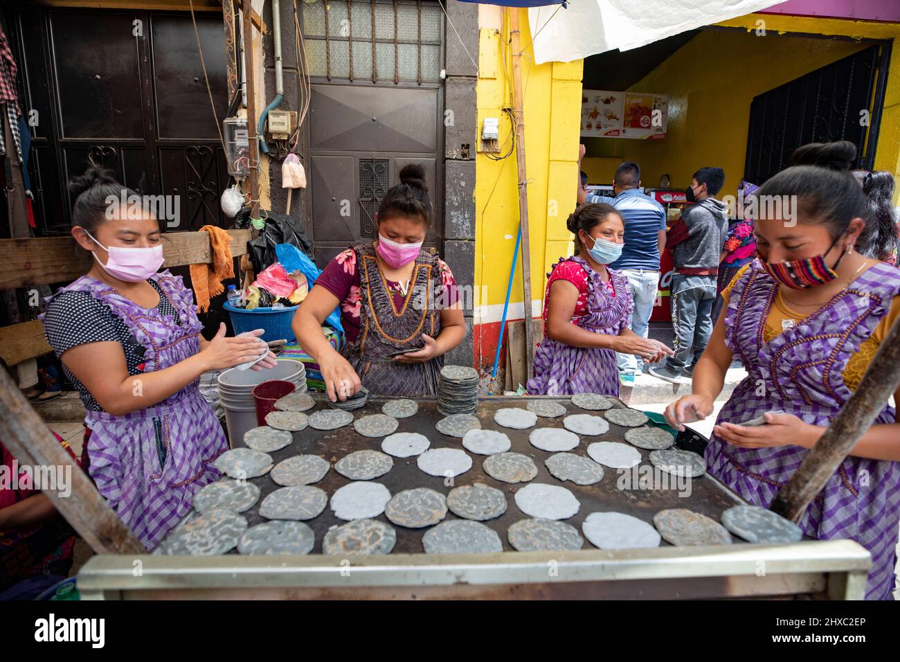 Street food stall at the colorful weekly Chichicastenango Mayan Market in Guatemala, Central America. Stock Photo