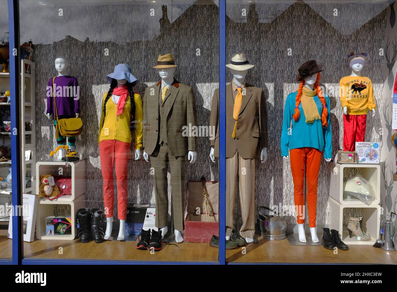 A very brightly dressed charity shop window. Stock Photo