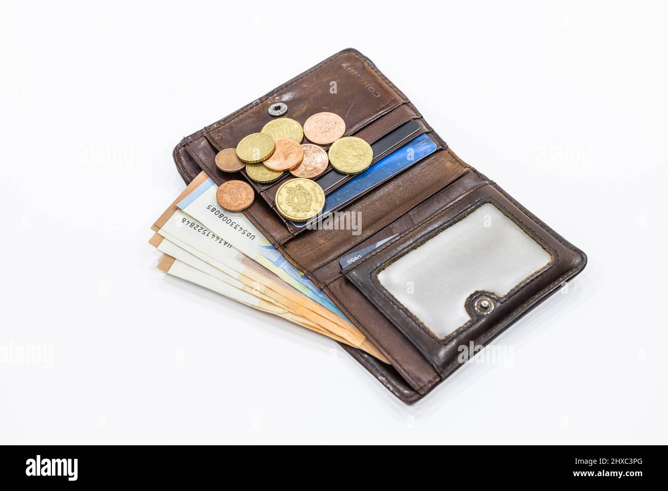 Open brown leather wallet with money and credit cards Stock Photo