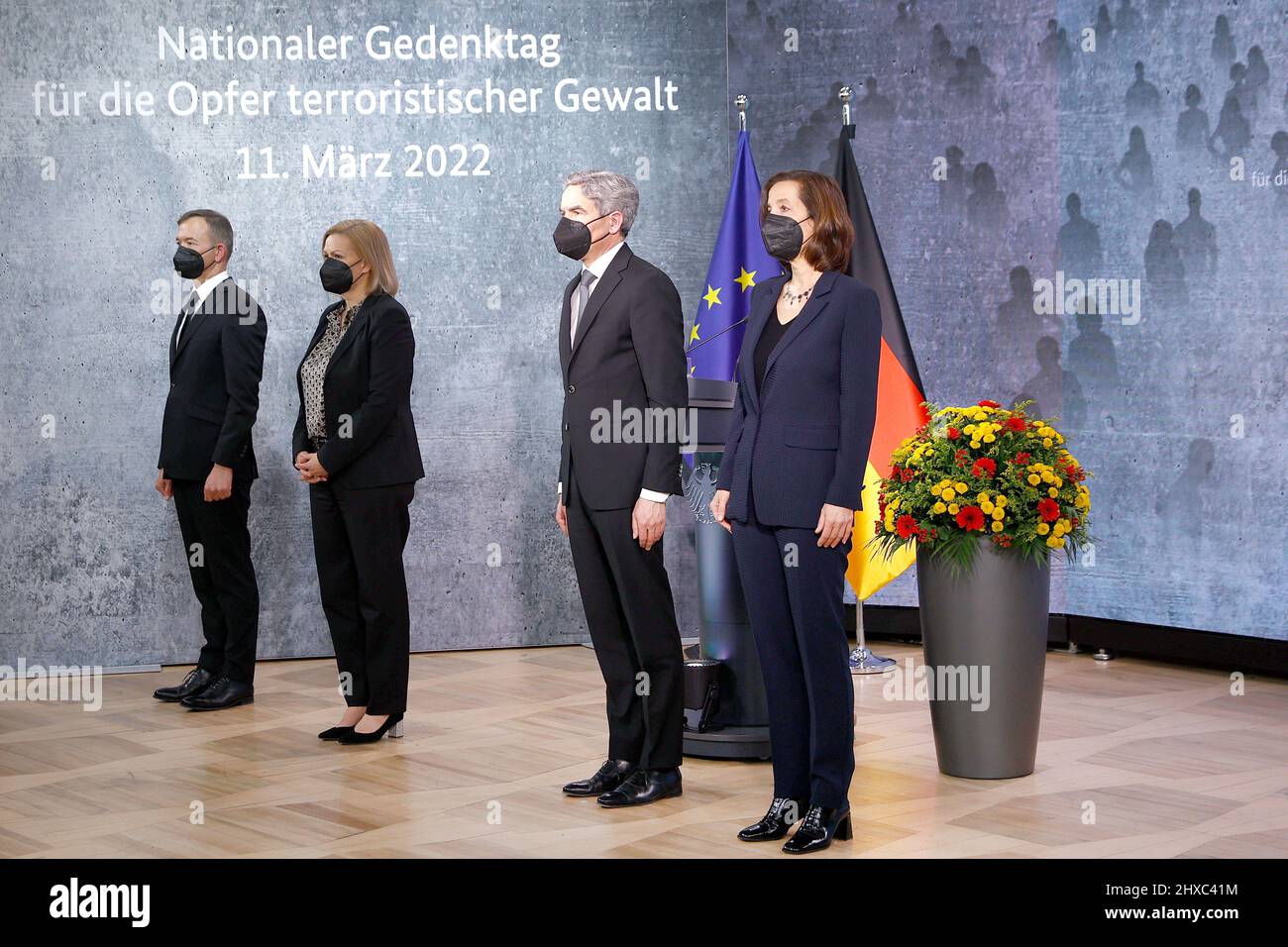 11 March 2022, Berlin: Pascal Kober (l-r), Federal Government Commissioner for the Concerns of Victims of Terrorist and Extremist Attacks in Germany, Nancy Faeser (SPD), Federal Minister of the Interior and Home Affairs, Stephan Harbarth, President of the Federal Constitutional Court, and Petra Terhoeven, historian, stand during the national anthem at the German government's commemoration of the victims of terrorist violence. The Day of Remembrance, which is to be held annually on March 11, ties in at the national level with the European Day of Remembrance, which was established after the Madr Stock Photo