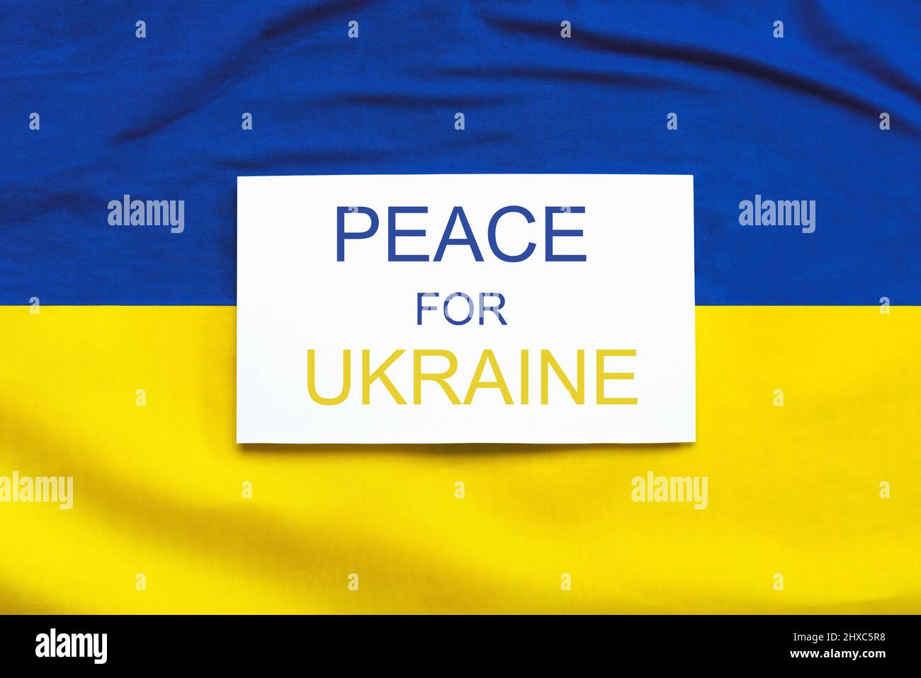 National flag of Ukraine background with white paper with the text Peace for Ukraine Stock Photo
