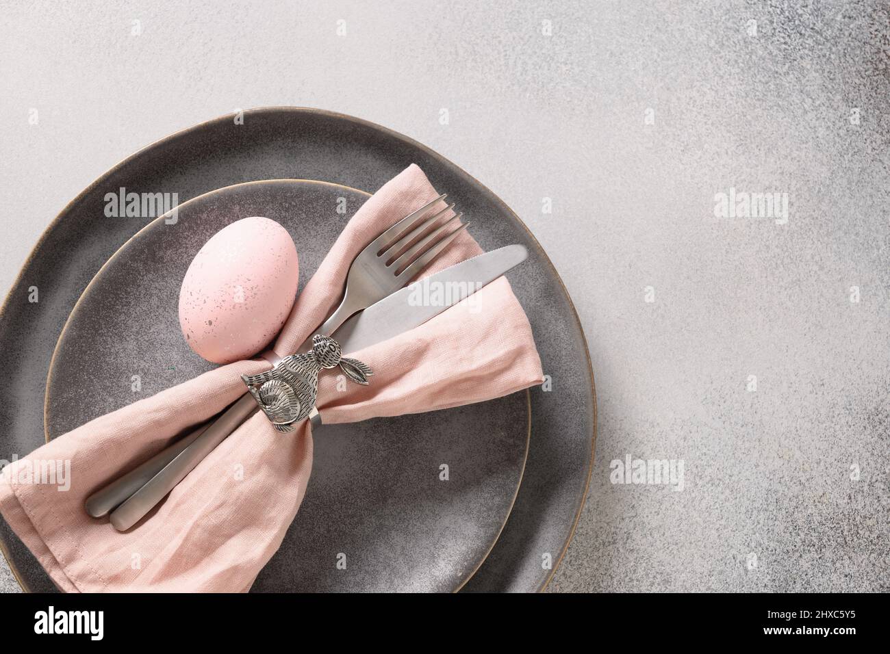 Easter dinner with pink egg, elegance table setting. Top view. Copy space. Stock Photo