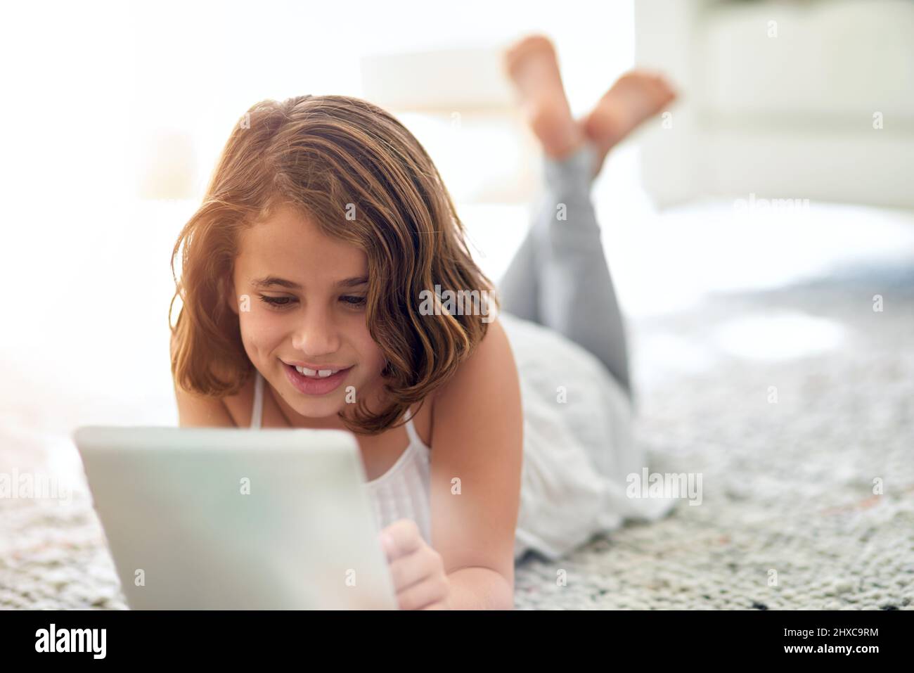 Cute and carefree. Shot of a cute little girl at home Stock Photo - Alamy