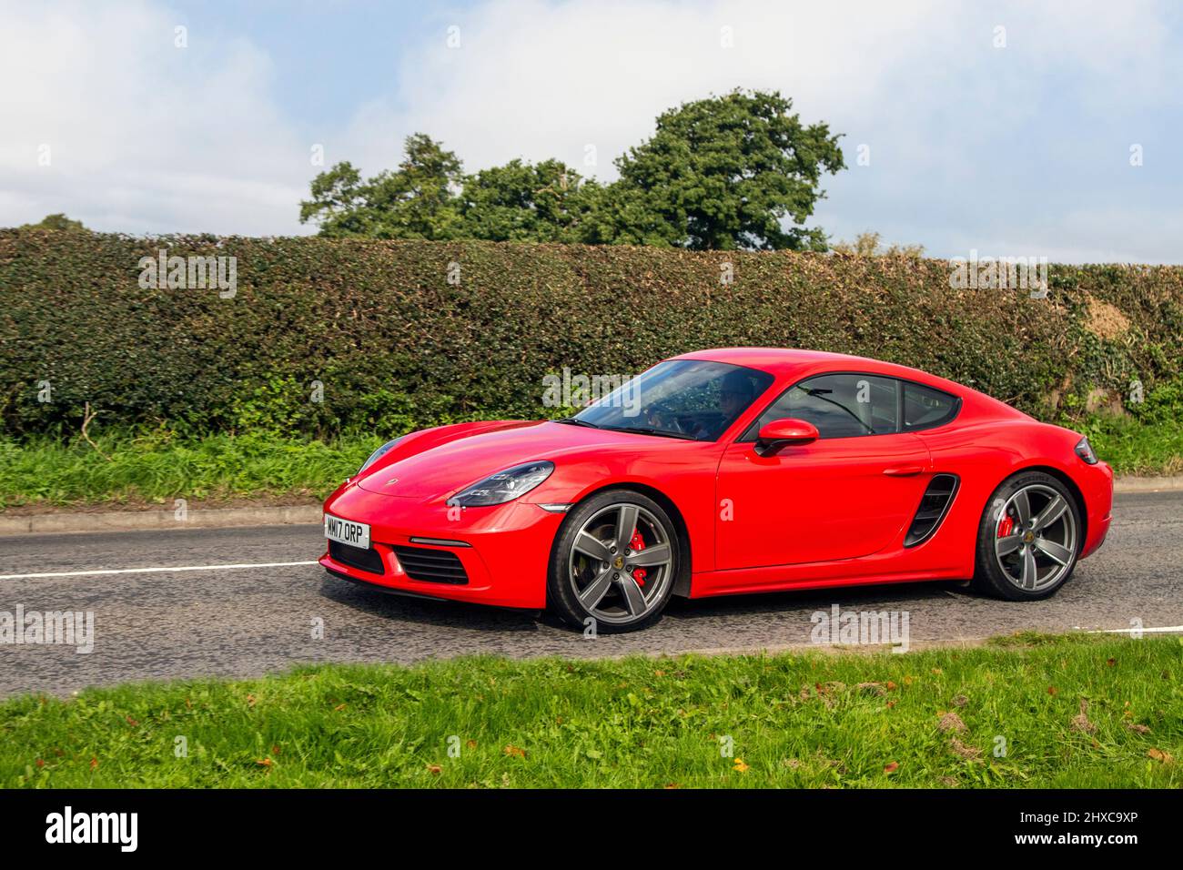 2017 red Porsche 718 Cayman S en-route to Capesthorne Hall classic August car show, Cheshire, UK Stock Photo