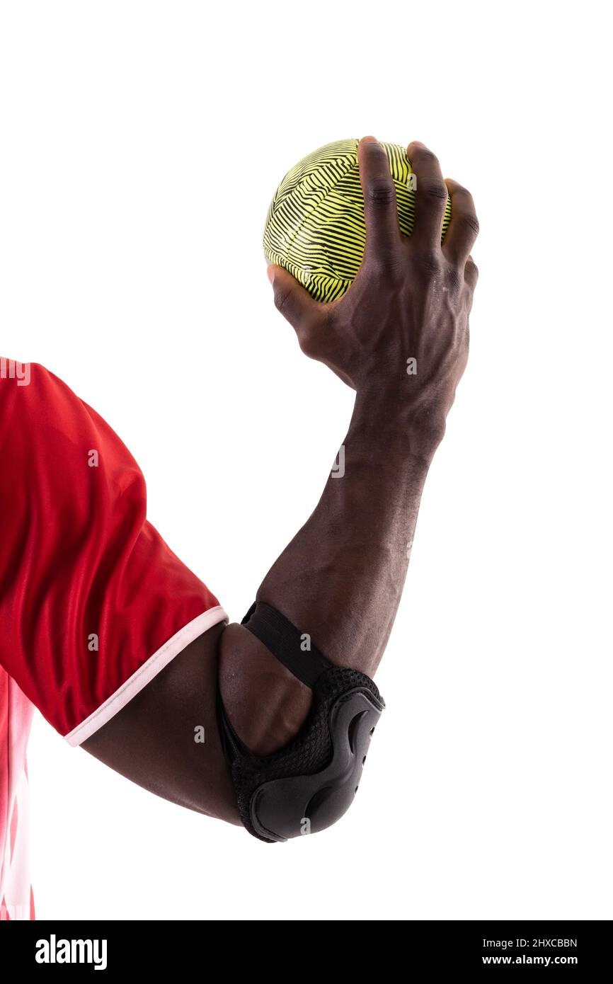 African american handball player wearing elbow guard holding green ball
