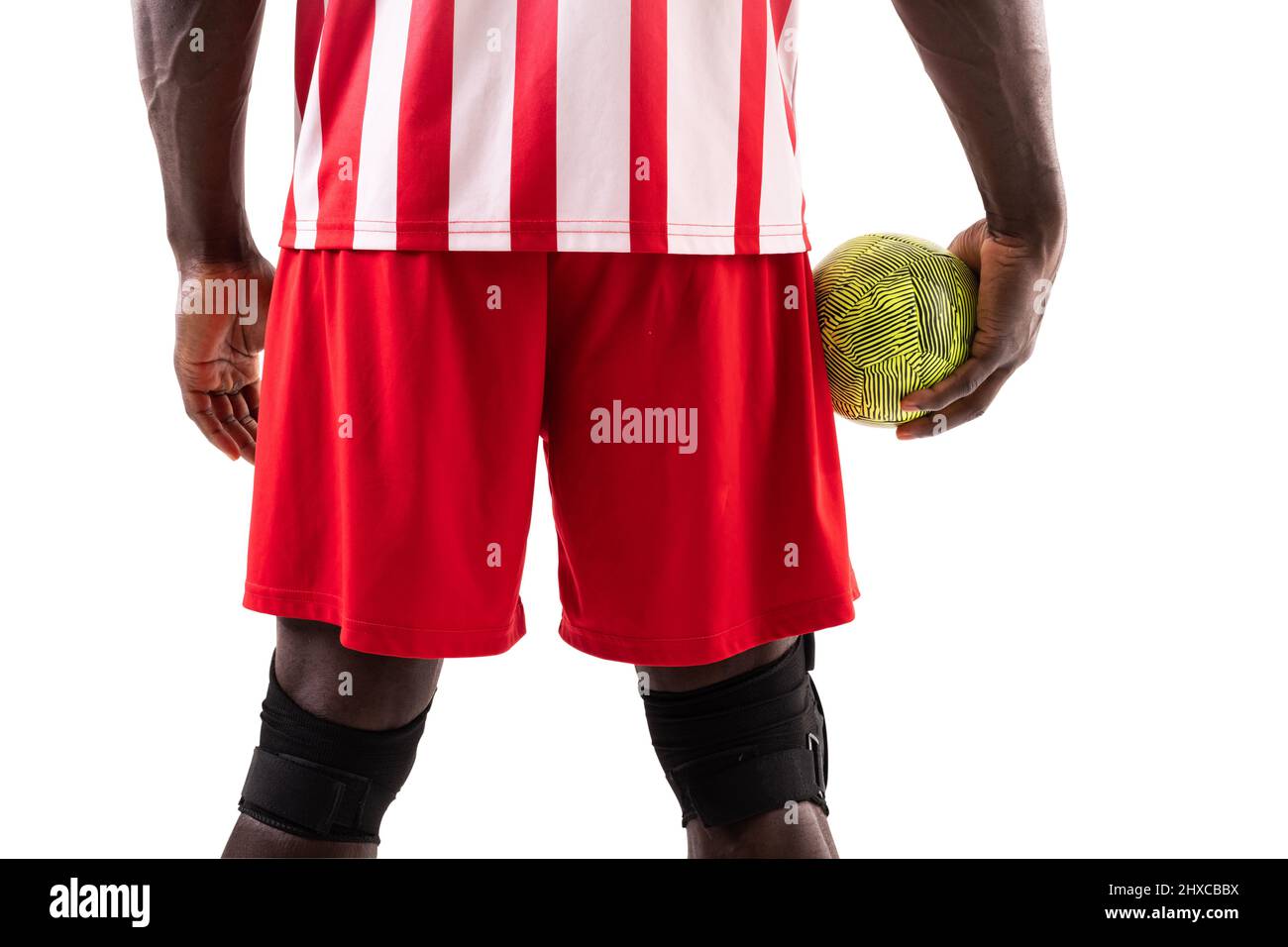 Midsection of african american male handball player holding green ball