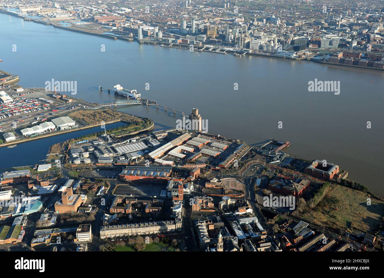 aerial view of Birkenhead looking across the Mersey towards Liverpool along the line of the Birkenhead Tunnel with the ferry terminal prominent also Stock Photo