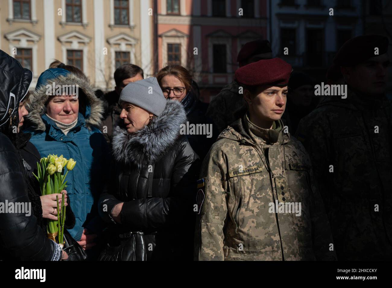Lviv, Ukraine. 11th Mar, 2022. A female soldier (R) seen in the street during the funeral service. The funeral of the three Ukrainian soldiers killed during the Russian Invasion of Ukraine, has been held in Lviv, at Saints Peter and Paul Garrison Church (also known as Jesuit Church). Credit: SOPA Images Limited/Alamy Live News Stock Photo