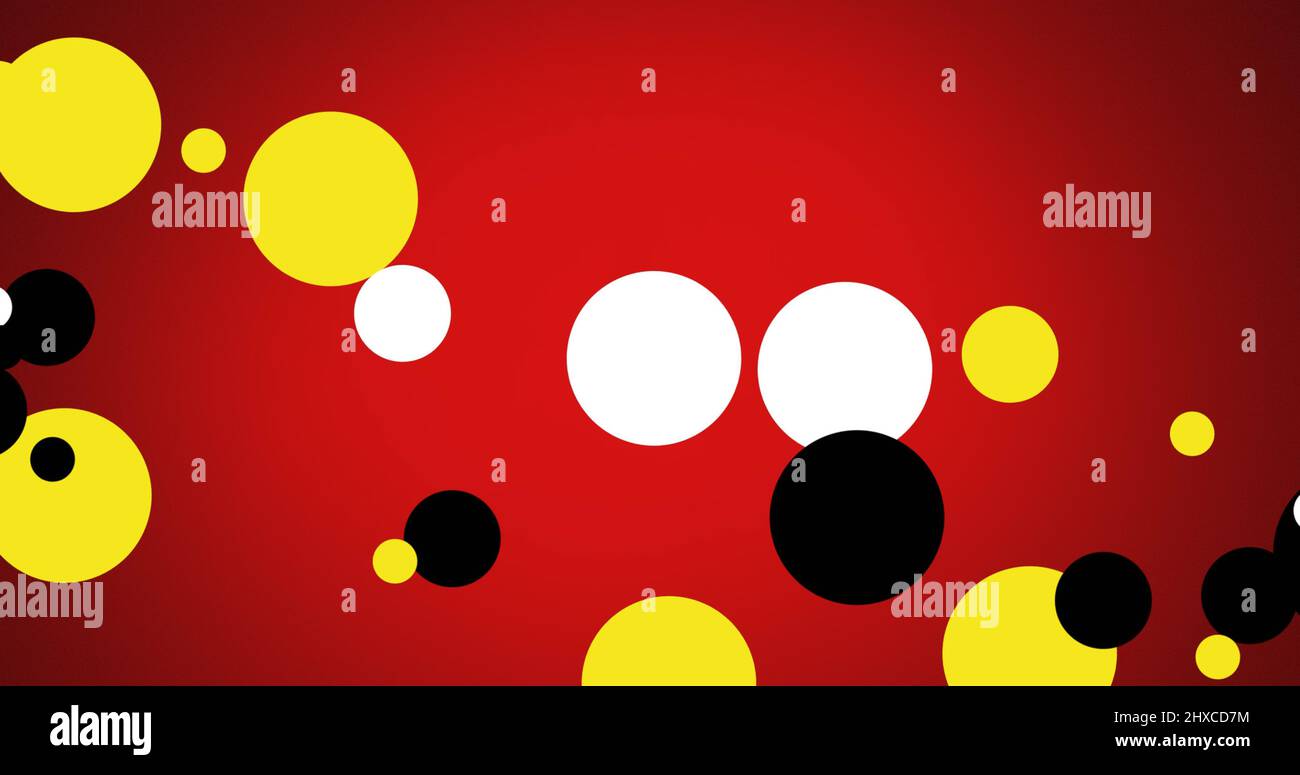 Image of yellow, black and white spots on red background Stock Photo